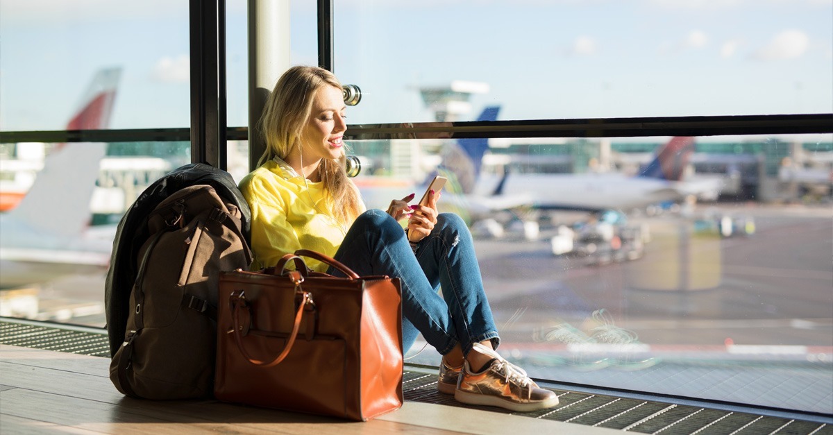 Person looking at a phone in an airport