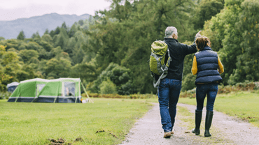 People walking in a campsite